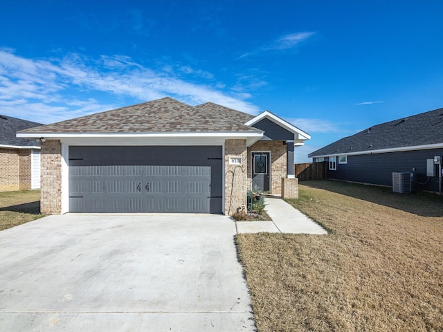 single story home with a front yard, a garage, and central AC