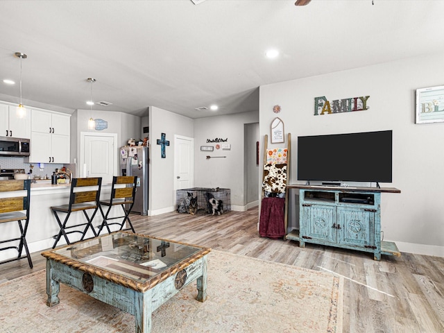 living room with light hardwood / wood-style flooring