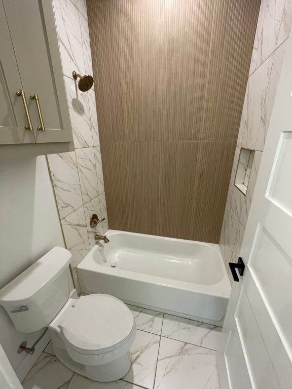 bathroom featuring shower / tub combination and toilet