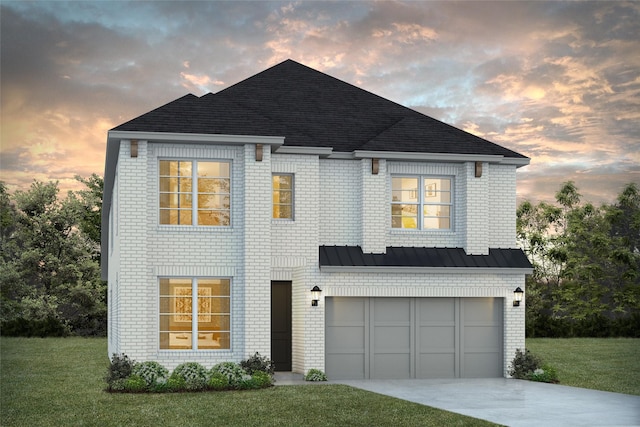 view of front of house with a yard and a garage