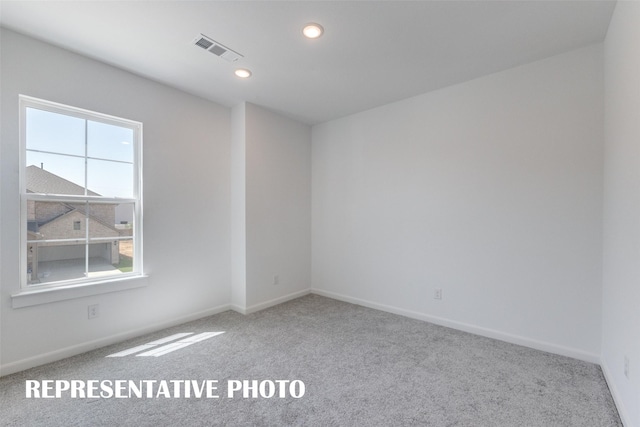 spare room featuring carpet floors