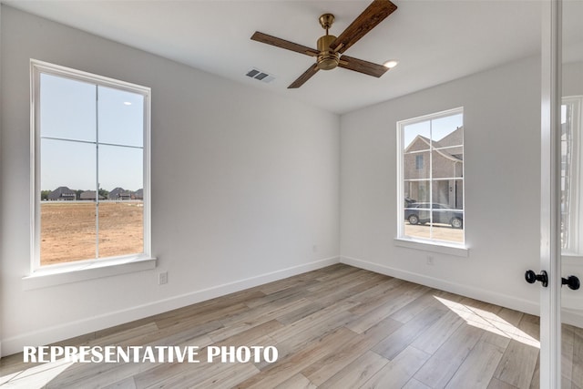 unfurnished room featuring light wood-type flooring and ceiling fan