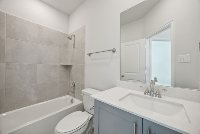 full bathroom featuring vanity, toilet, and tiled shower / bath