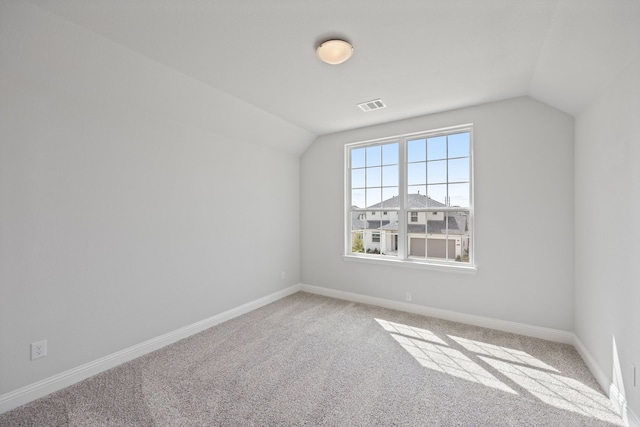 bonus room featuring light carpet and lofted ceiling