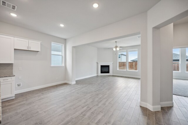 unfurnished living room featuring ceiling fan