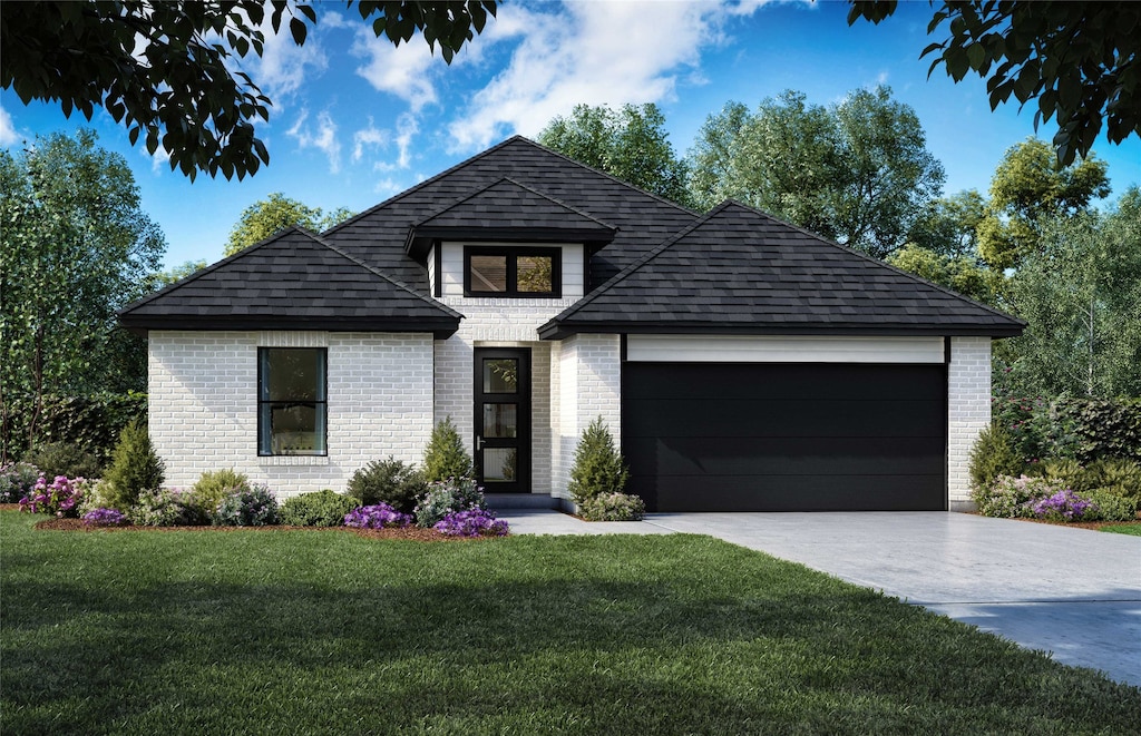 view of front of house with a front yard and a garage