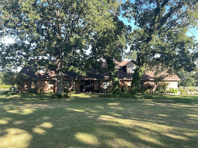 view of front of property with a front yard and a garage