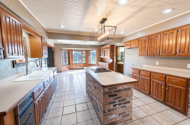 kitchen featuring a sink, black electric stovetop, brown cabinets, and light tile patterned flooring