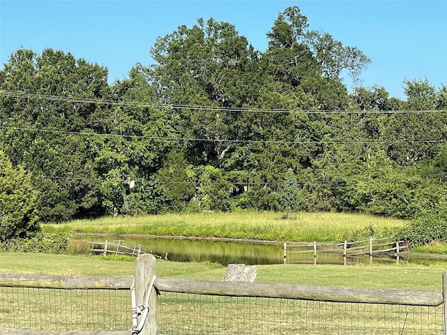 view of yard with fence and a water view