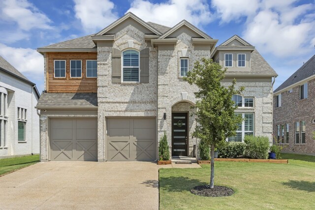 view of front facade with a front yard and a garage