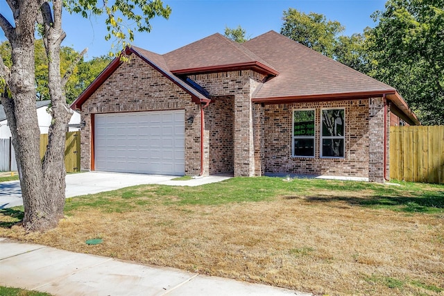 view of front of house featuring a garage and a front lawn