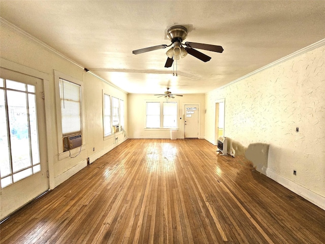 empty room with ceiling fan, cooling unit, a textured ceiling, hardwood / wood-style flooring, and ornamental molding