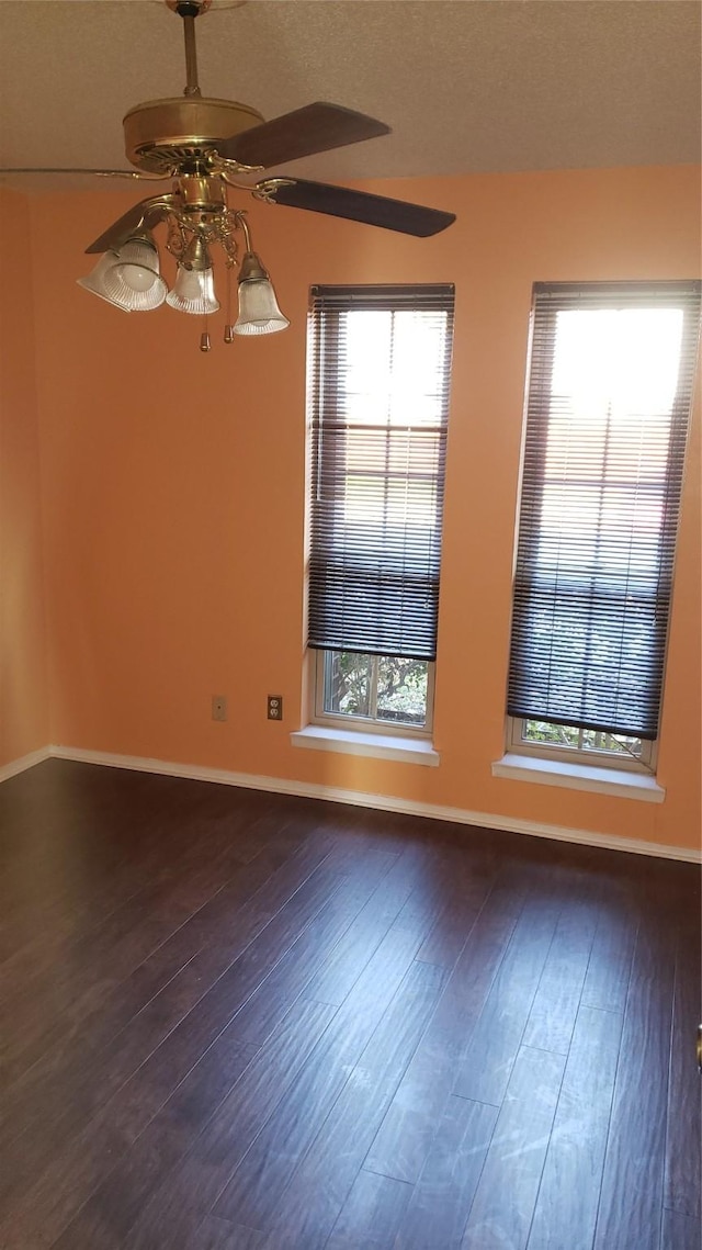 spare room featuring ceiling fan and dark hardwood / wood-style flooring