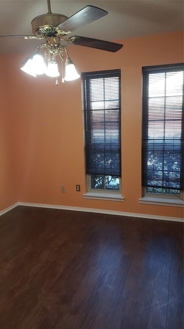 spare room featuring wood-type flooring and ceiling fan