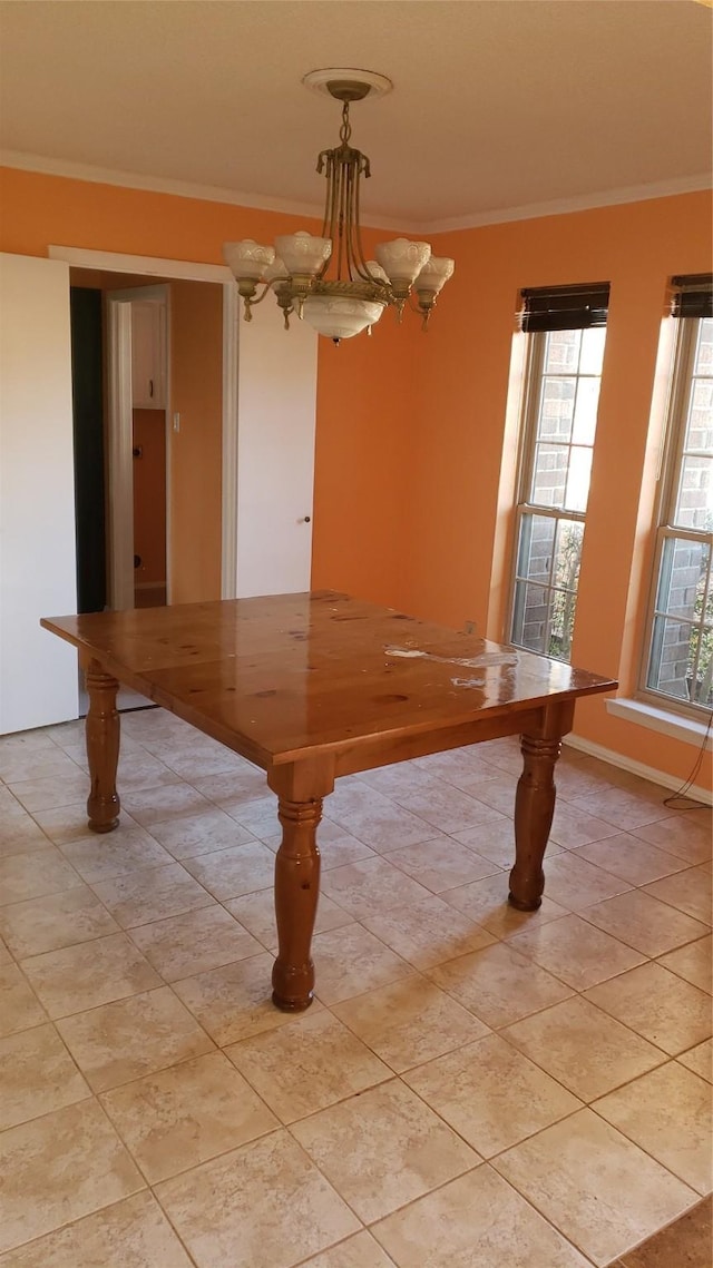 unfurnished dining area with crown molding, a chandelier, and light tile patterned flooring