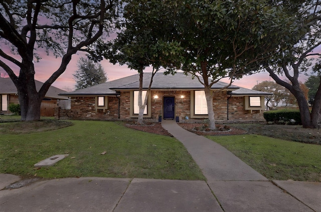 ranch-style house with a yard