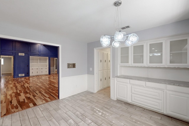 unfurnished dining area with light hardwood / wood-style floors