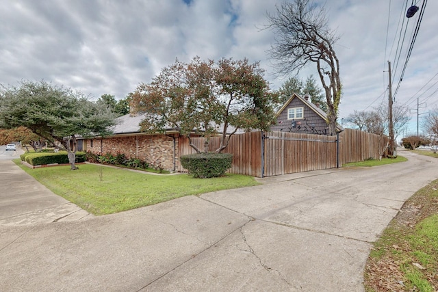 view of side of home with a yard