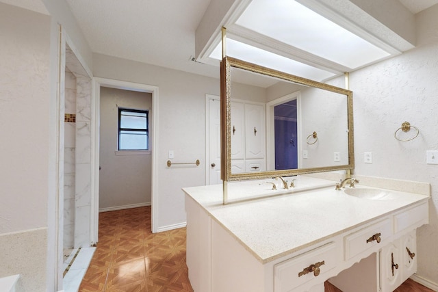 bathroom featuring vanity and parquet flooring