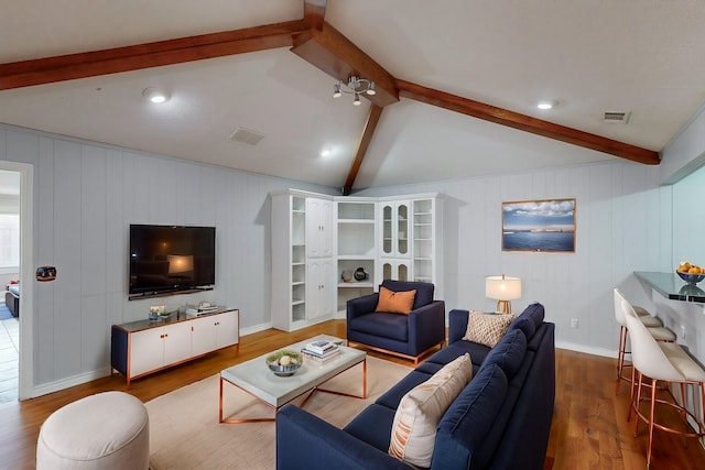 living room featuring vaulted ceiling with beams and wood-type flooring