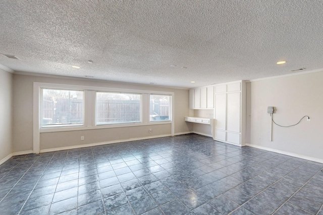 tiled empty room with a textured ceiling and ornamental molding