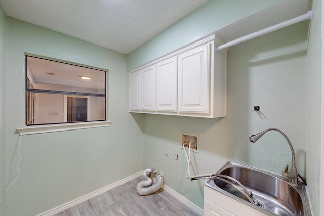 laundry area with cabinets, hookup for a washing machine, light wood-type flooring, gas dryer hookup, and sink