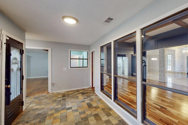 hall with a textured ceiling and french doors