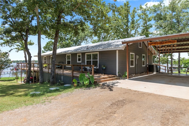 view of front of property with a carport and central AC