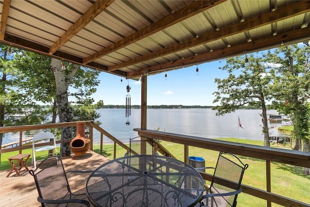 wooden terrace featuring a water view