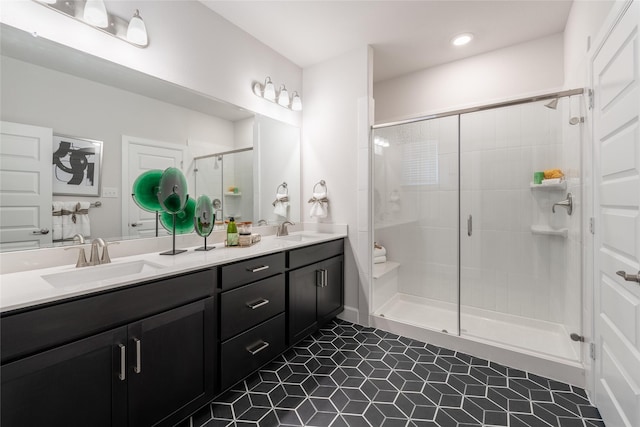 bathroom with tile patterned floors, a shower with door, and vanity