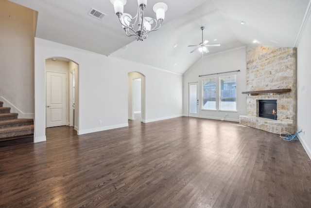 unfurnished living room featuring dark wood-type flooring, high vaulted ceiling, a stone fireplace, and ceiling fan with notable chandelier