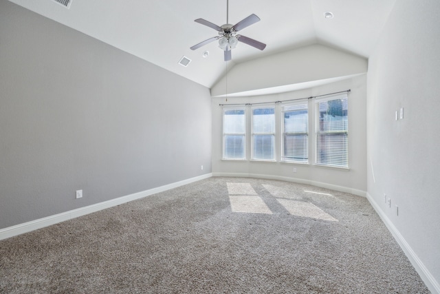 spare room featuring ceiling fan, lofted ceiling, and carpet floors