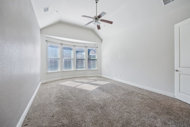 carpeted spare room featuring ceiling fan and vaulted ceiling