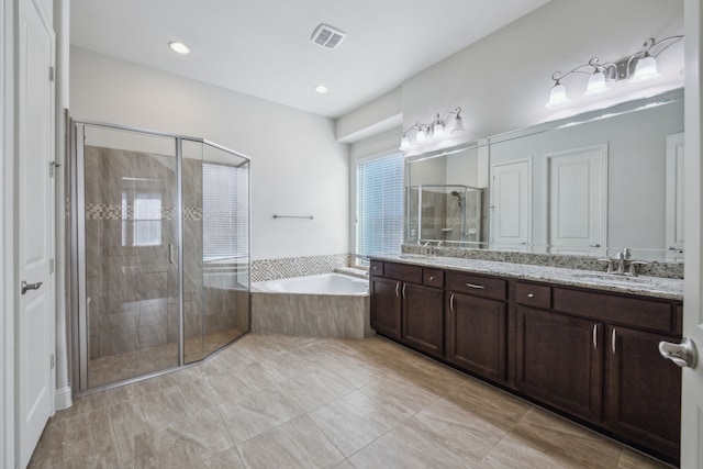 bathroom with vanity and separate shower and tub