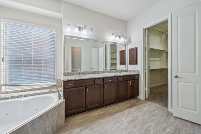 bathroom with vanity and a relaxing tiled tub