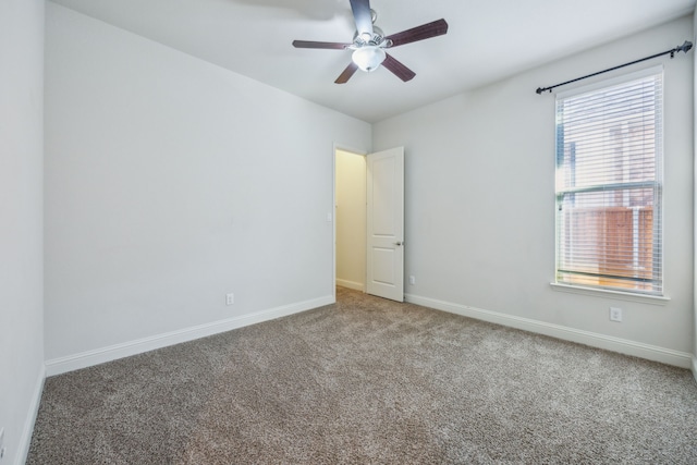 empty room featuring ceiling fan and carpet flooring