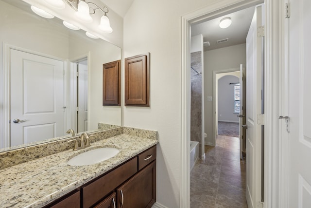 bathroom featuring vanity and shower / tub combination