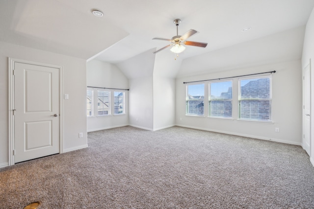 interior space featuring vaulted ceiling, ceiling fan, and carpet floors