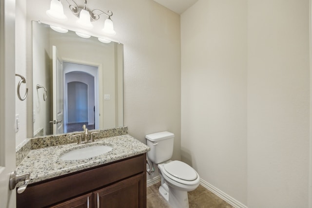 bathroom featuring vanity, tile patterned floors, and toilet