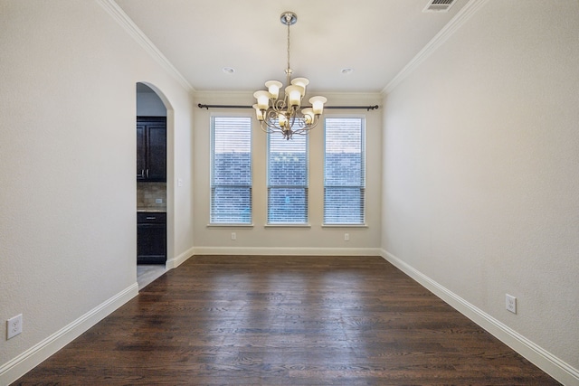 unfurnished dining area with crown molding, dark hardwood / wood-style floors, and an inviting chandelier