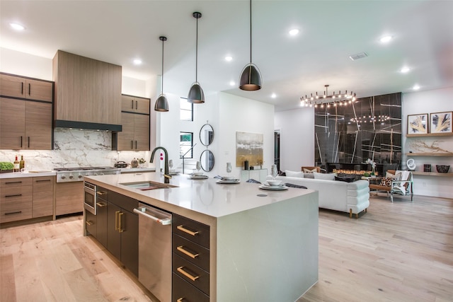 kitchen featuring light countertops, light wood-style floors, and a sink