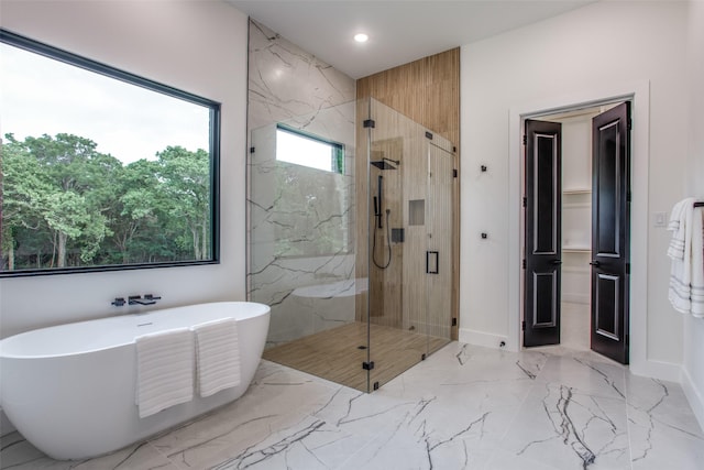 bathroom featuring a marble finish shower, a soaking tub, marble finish floor, and recessed lighting