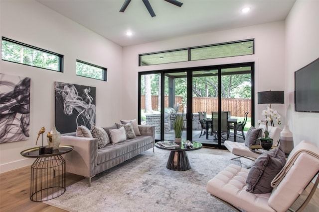 living room with recessed lighting, a ceiling fan, baseboards, and wood finished floors