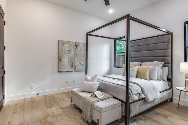 bedroom with recessed lighting, baseboards, and wood finished floors