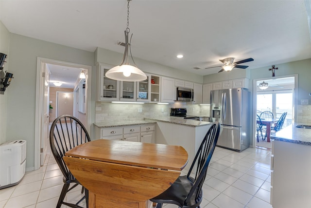 dining area with ceiling fan and light tile patterned floors