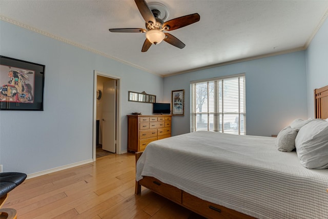 bedroom featuring ornamental molding, light hardwood / wood-style floors, and ceiling fan