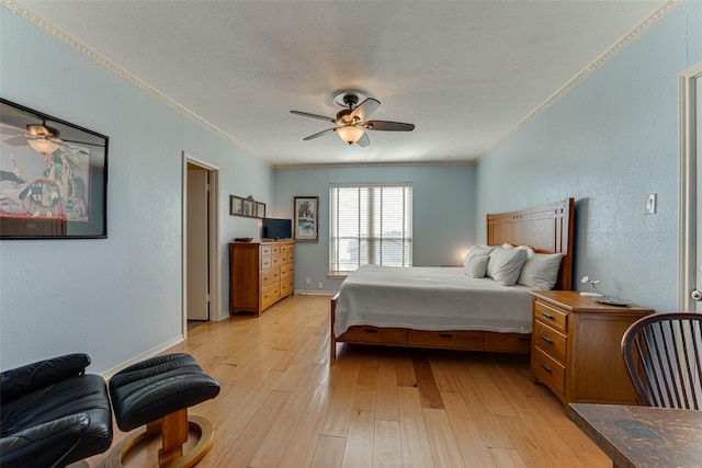 bedroom featuring a textured ceiling, ornamental molding, light hardwood / wood-style floors, and ceiling fan