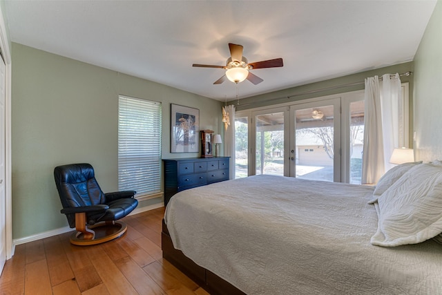 bedroom with hardwood / wood-style floors, access to outside, french doors, and ceiling fan