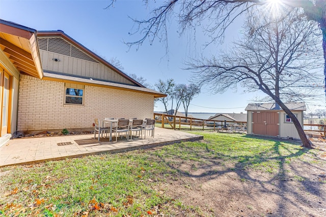 view of yard featuring a patio and a storage unit