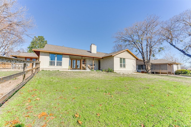 back of house featuring french doors and a yard